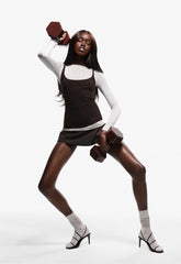 a model holding a brown dumbbell