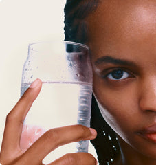 model holding a glass of water